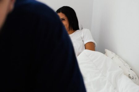 woman lying on bed in room